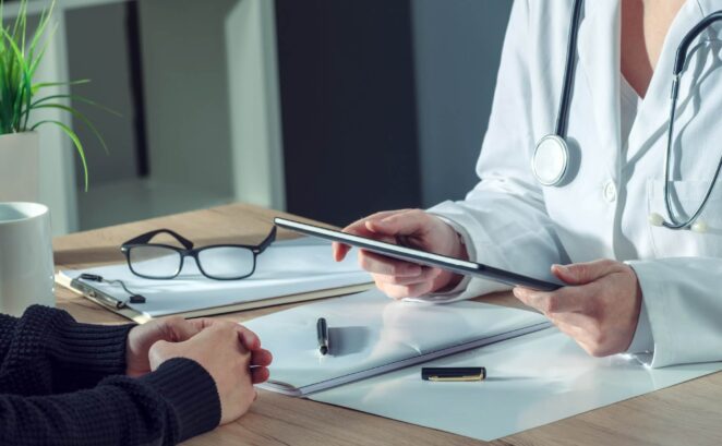 a doctor is consulting with a patient who is planning to receive a hip replacement surgery.