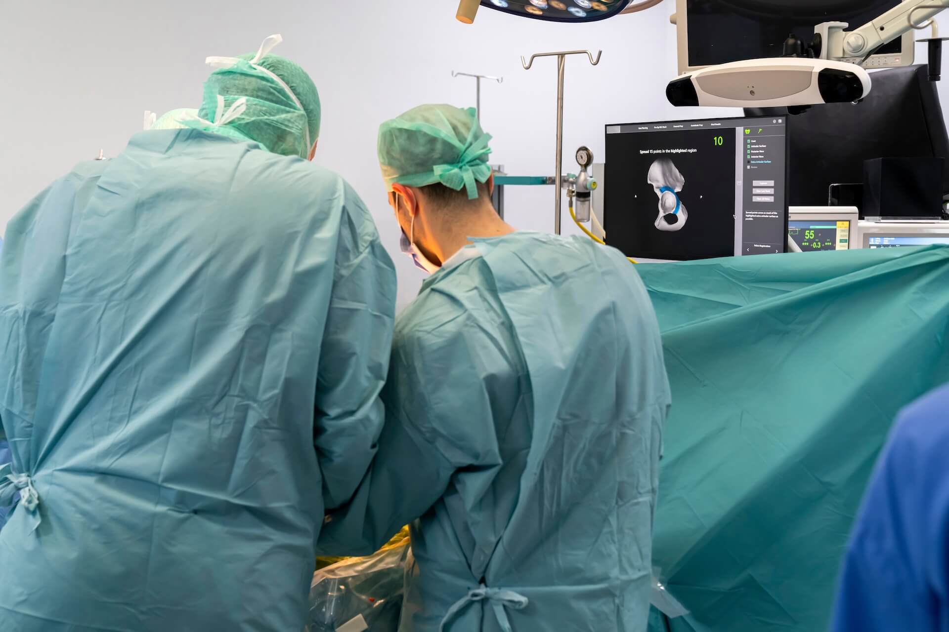 two surgeons are proving hip replacement operation for their patient.