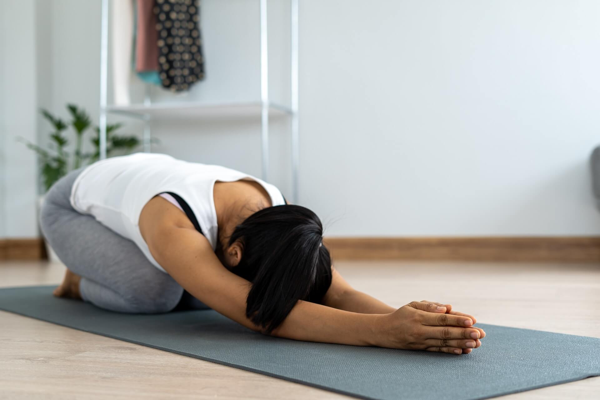 a woman is stretching her back muscles