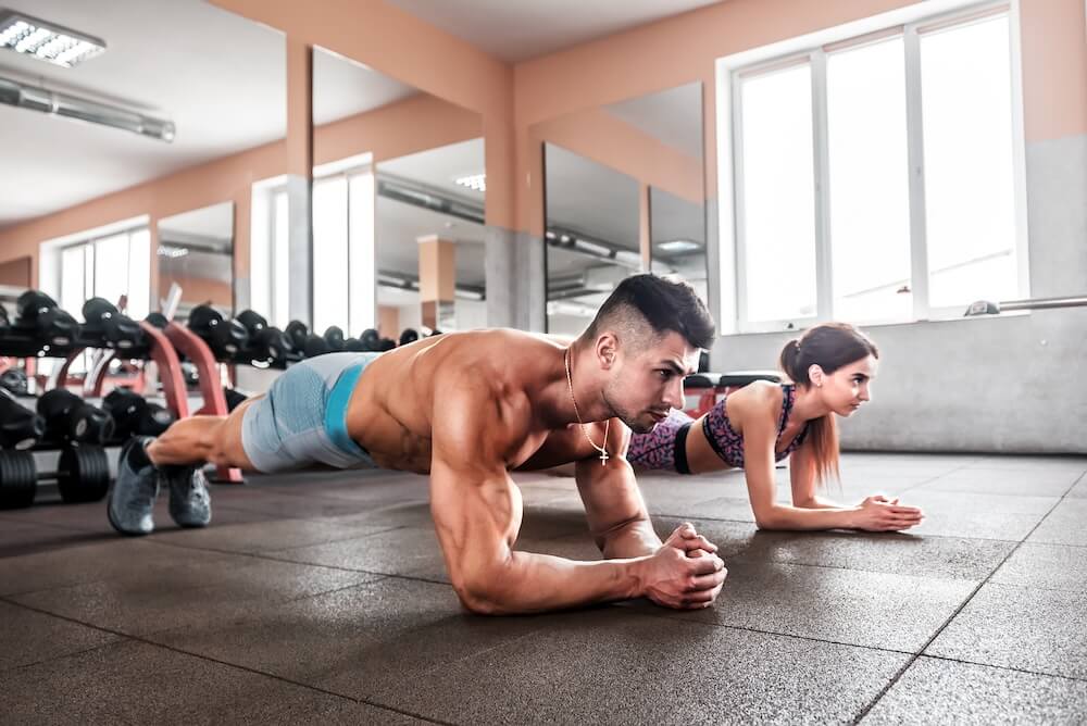 a couple working out for their abdominal muscles