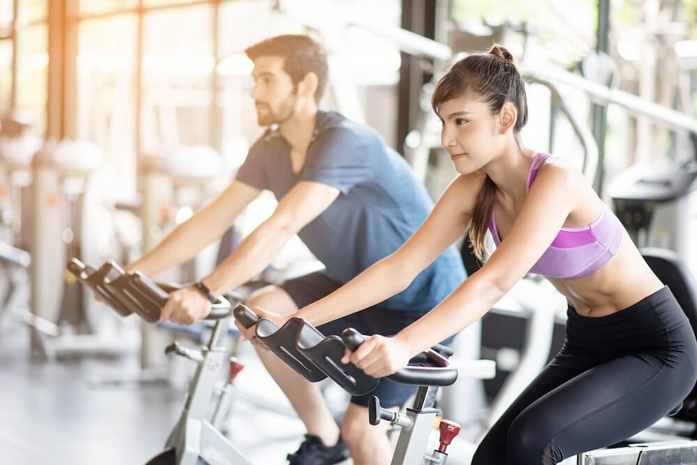 a lady is using an exercise bike for her fitness work out